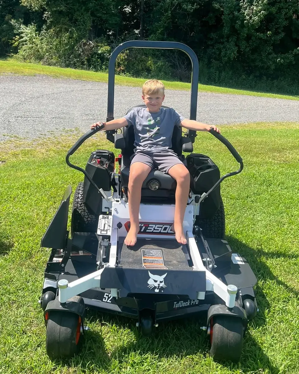 Young customer sitting on a new Bobcat zero-turn mower
