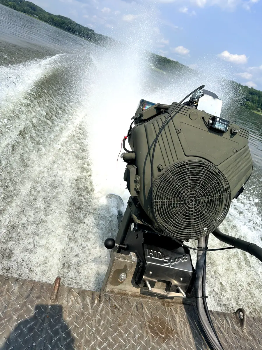 Surface drive mud motor throwing water on a boat run